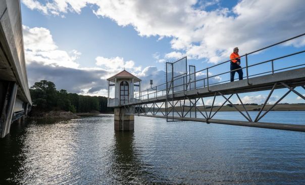 A field officer works at Pykes Creek Reservoir at Myrniong outside Bacchus Marsh in Southern Victoria.