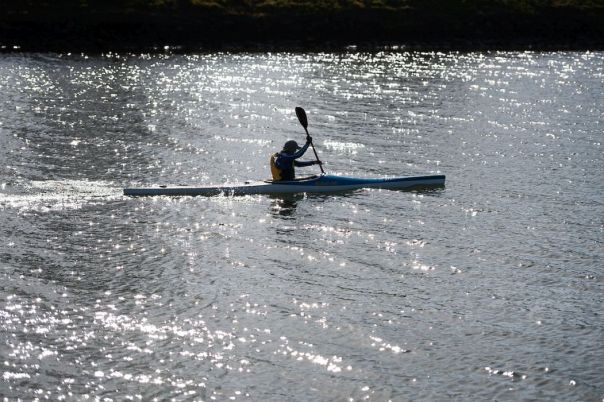 view of a person kayaking in a river