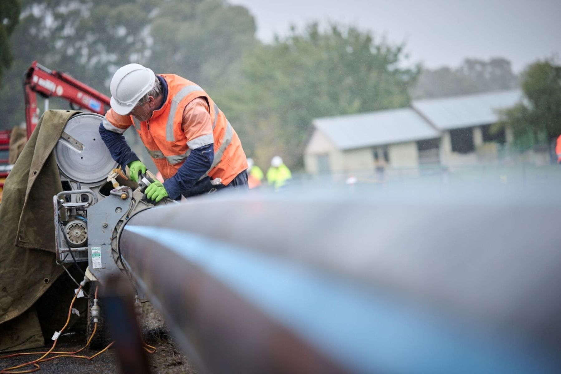 Person in hi vis vest using tools