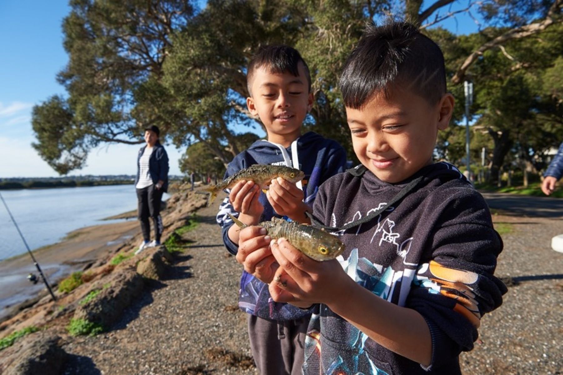 kids holding fish near barwon river