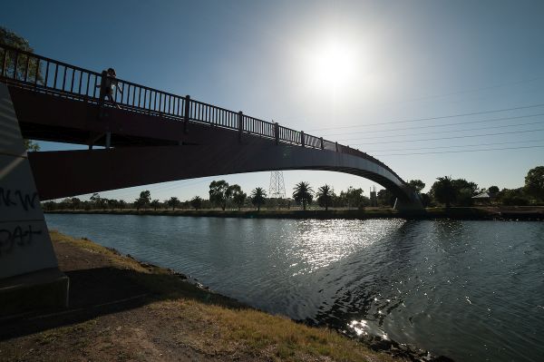 A bridge over a river on a cloudy day.  