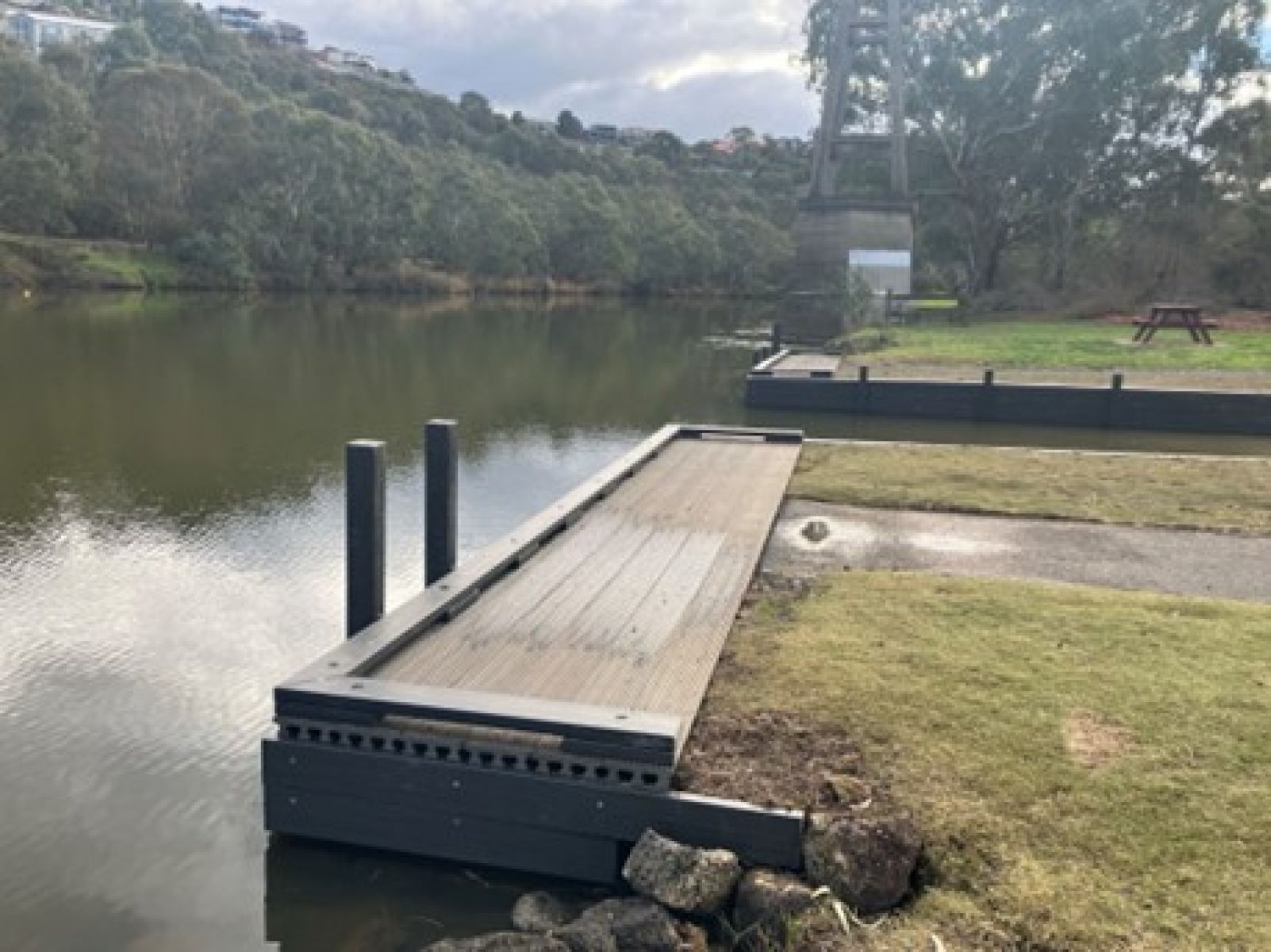 A wooden boat ramp by a river