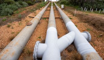 3 long water pipes extend across the landscape, the centre and right pipes are inter-connected.
