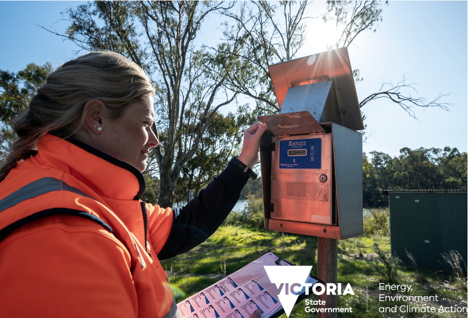 Decorative: field officer reading a telemetry device in a field