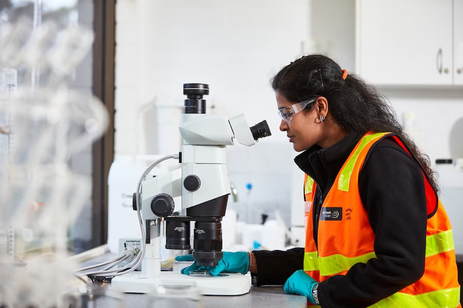 Woman looking through microscope