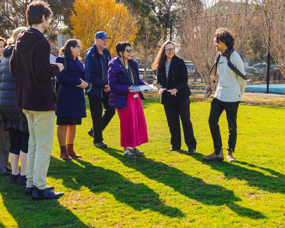 A small group of people gathered on the lawn at AG Gillion oval for a funding announcement